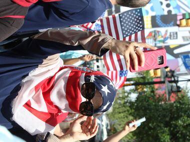 Fouzia Al-Amoodi, of Irving, Texas, takes a picture during the Dallas Mega March on Sunday,...