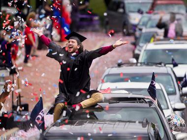 Graduate William Santini celebrates as confetti falls during a commencement car parade at...