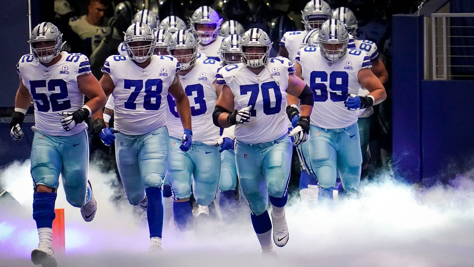 Dallas Cowboys offensive guard Zack Martin (70) leads the team onto the field to face the New York Giants in an NFL football game at AT&T Stadium on Sunday, Oct. 11, 2020, in Arlington.