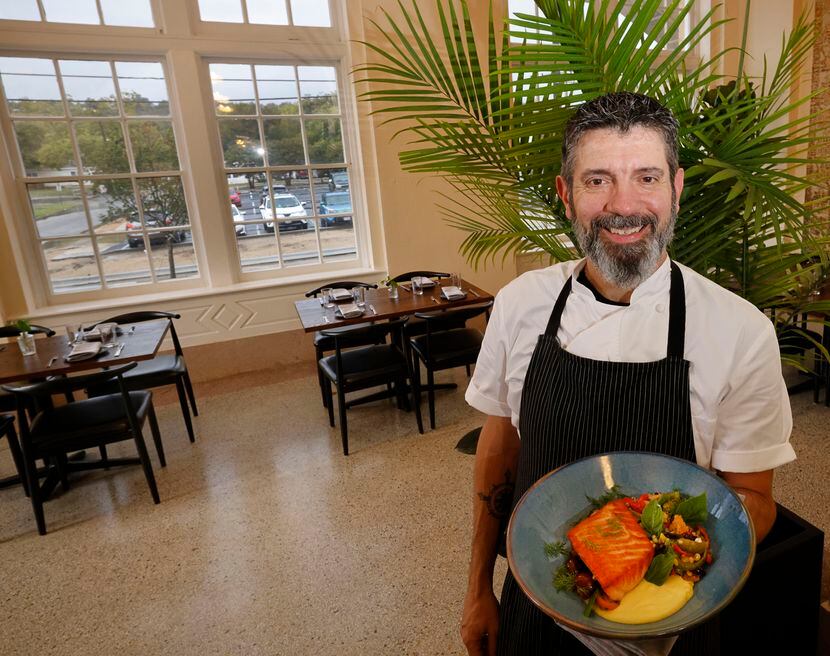 Executive Chef David Bull holds a salmon dish, Broiled Salmon Filet, in SECOND Bar+Kitchen...