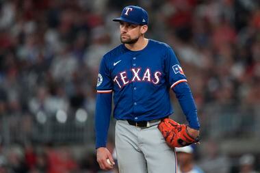 Texas Rangers pitcher Nathan Eovaldi waits on the mound to be relieved in the sixth inning...