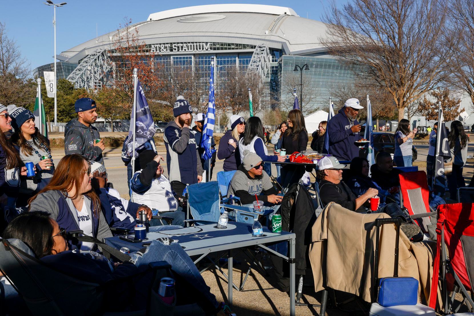 Fans watch an NFL wild-card playoff game between the Dallas Cowboys and the San Francisco...