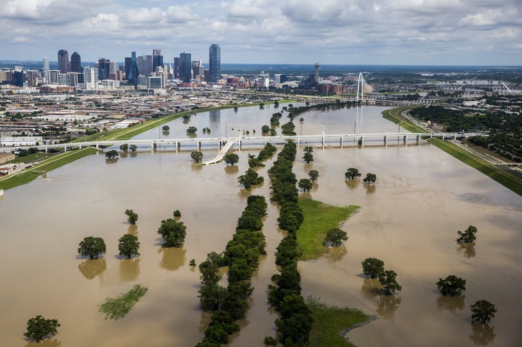 The swollen Trinity River runs toward downtown Dallas on Friday, May 29, 2015. (Smiley N....