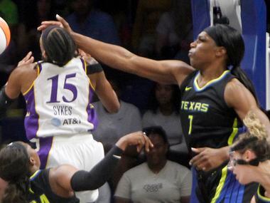 Dallas Wings center Teaira McCowan (1) extends a hand defensively to impede the offensive...