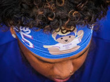 Texas Rangers outfielder Willie Calhoun wears a headband with his nickname “Osito” before a...