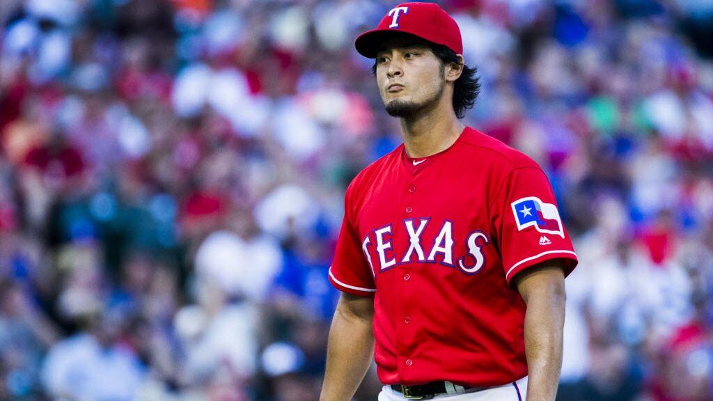 Texas Rangers starting pitcher Yu Darvish (11) walks off the field after the top of third...