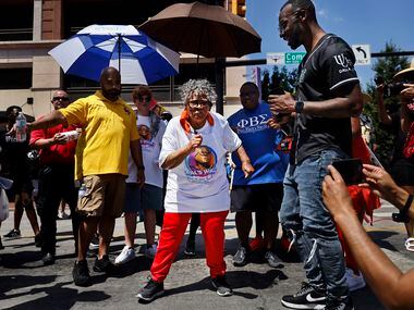 During her walk through downtown Fort Worth, Opal Lee (center) stopped in the middle of Commerce Street and danced to a live music show for her on Saturday morning June 19, 2021. For the first time since the realization of his dream of Juneteenth.  a national holiday has come true, Ms Opal Lee drove a 2.5 mile caravan from Historic Southside to the Tarrant County Courthouse in downtown Fort Worth.  Earlier this week, the civil rights icon backed President Joe Biden as he signed a law making Juneteenth a federal holiday.  At 94, Ms Opal Lee made her mark on Juneteenth by addressing supporters at the historic courthouse after cooling off after the hot march.  (Tom Fox / The Dallas Morning News) 