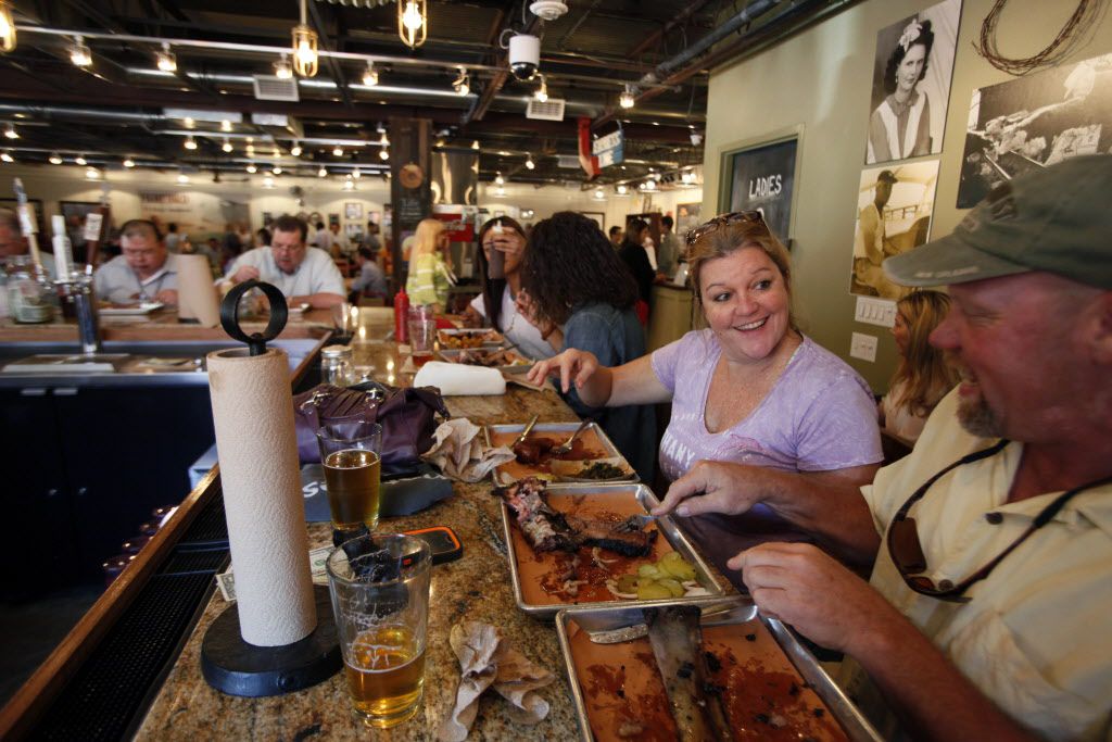 Patti Byrd and Kevin Watterud have lunch at the bar area inside the Pecan Lodge restaurant...