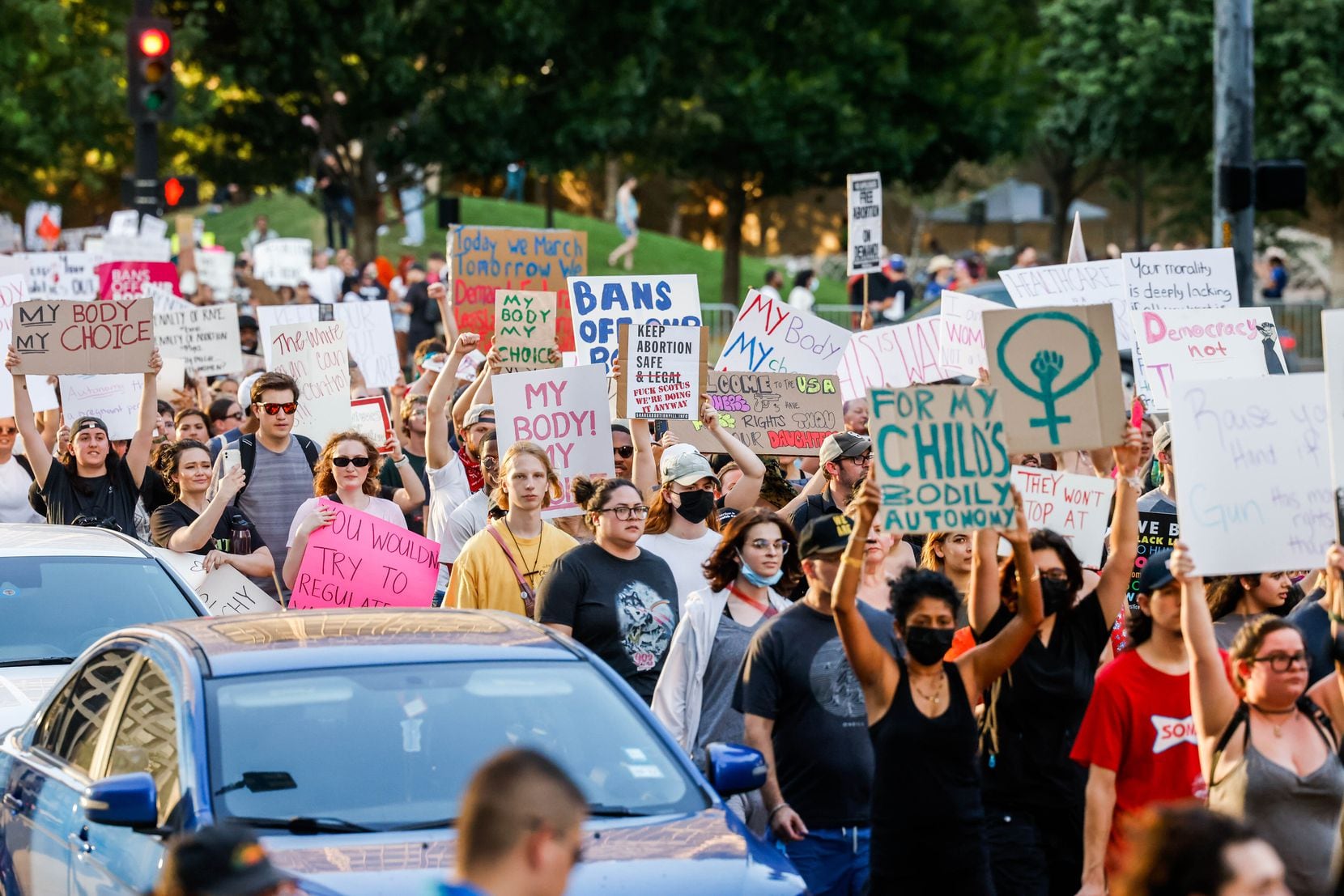 A group of demonstrators march from the Civic Garden along Main Street in downtown Dallas.