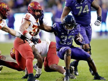 TCU Horned Frogs running back Kendre Miller (33) gives a stiff arm to Iowa State Cyclones...