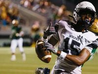 Mansfield Timberview wide receiver Titus Evans (15) throws up a hand sign after crossing...
