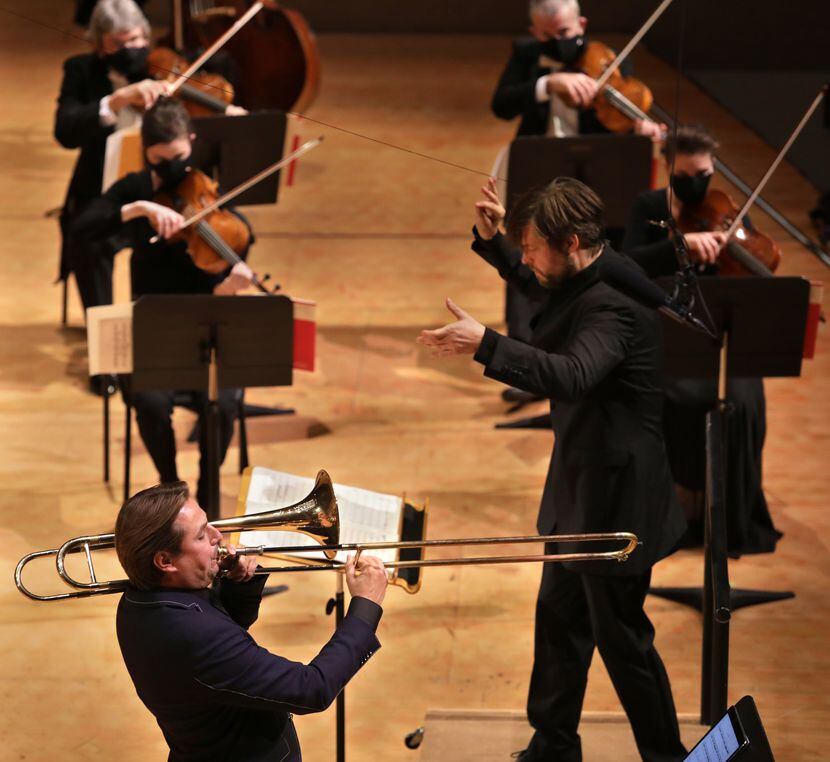 Jörgen van Rijen plays trombone as Juraj Valčuha conducts during a Dallas Symphony Orchestra...