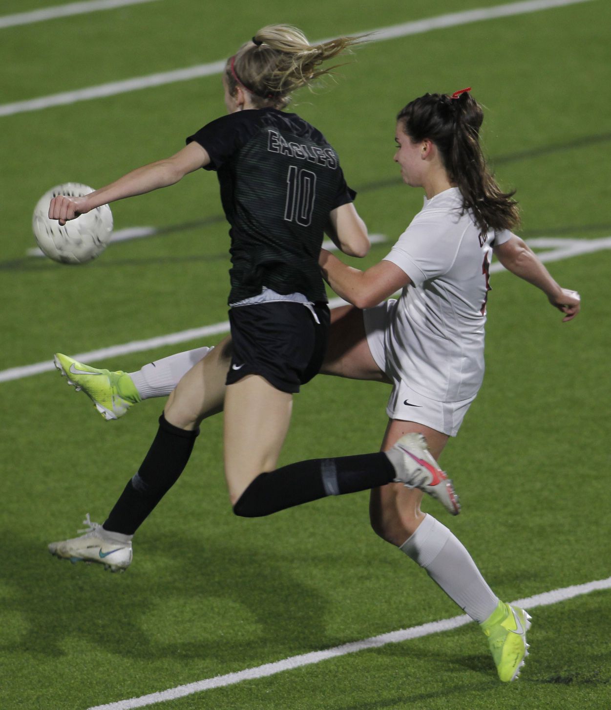Prosper's Hadley Murrell (10), left, and Coppell's Claire Yaney (14) vie for ball possession...