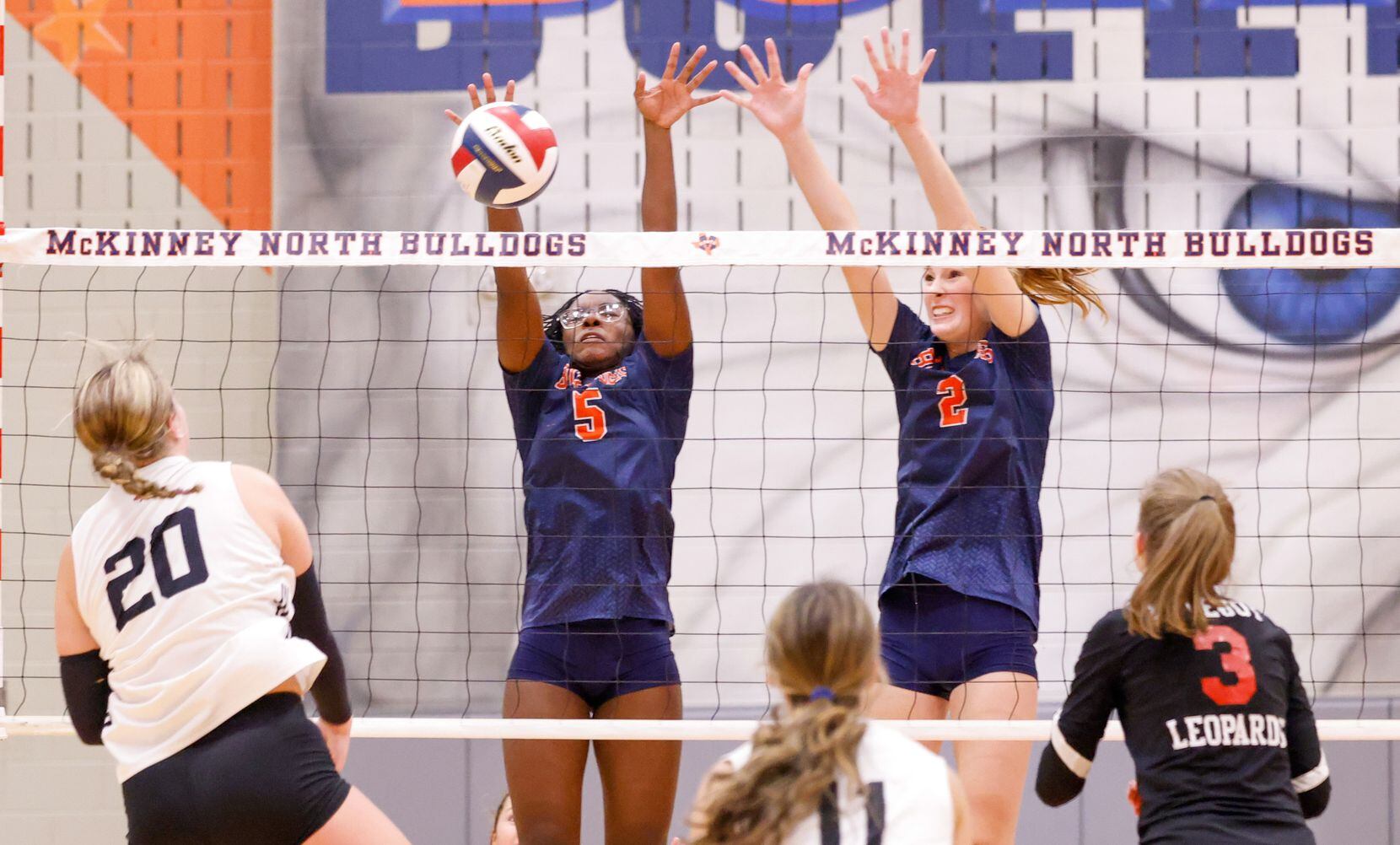 McKinney North Ayanna Moore (5) and Kayli Henderson (2) block a spike by Lovejoy Reagan...