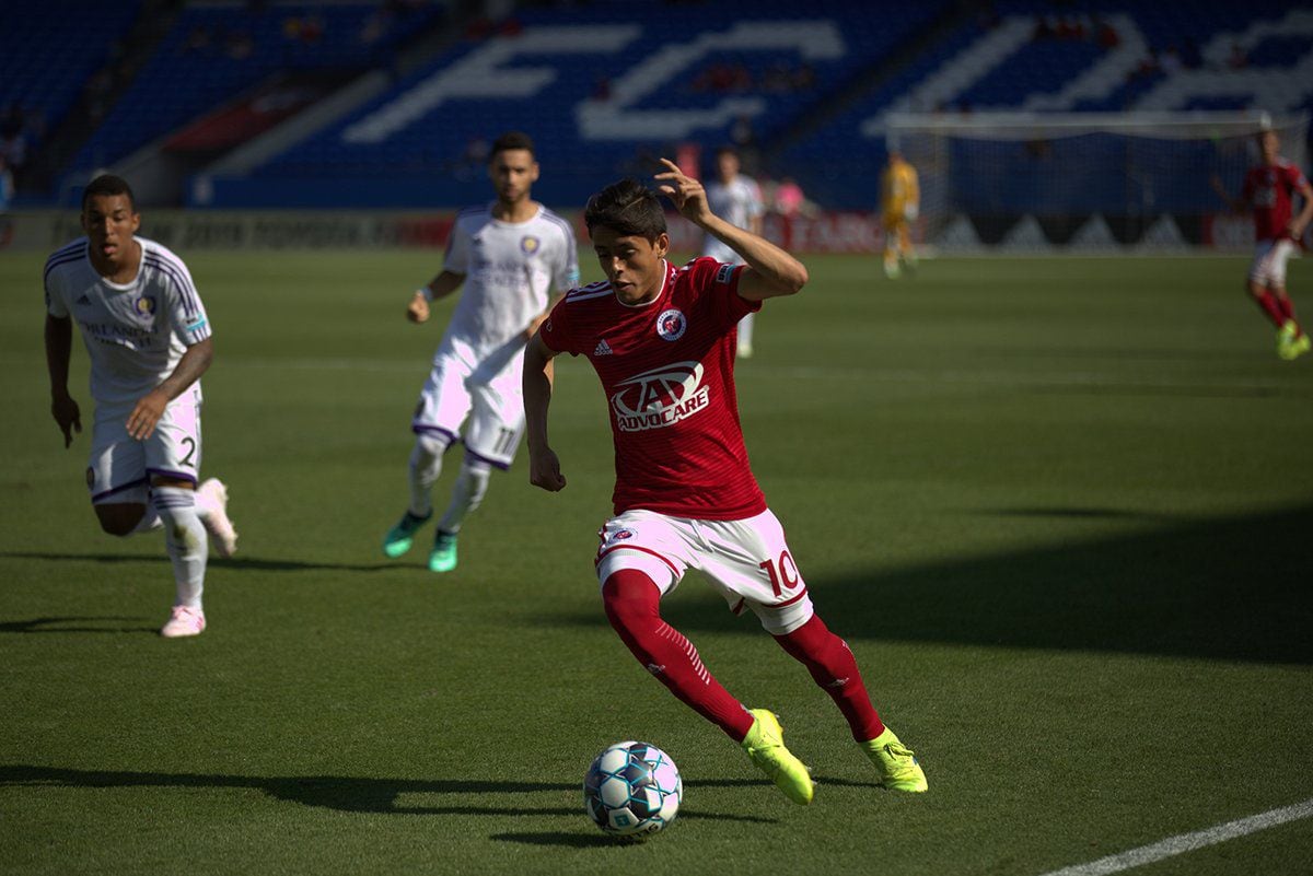 Arturo Rodriguez dribbles up field against Orlando City during USL League One play at Toyota Stadium in Frisco, Texas.