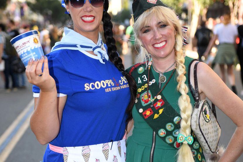 Cosplayers portraying Robin Scoops Ahoy from "Stranger Things" and a girl scout attend the...
