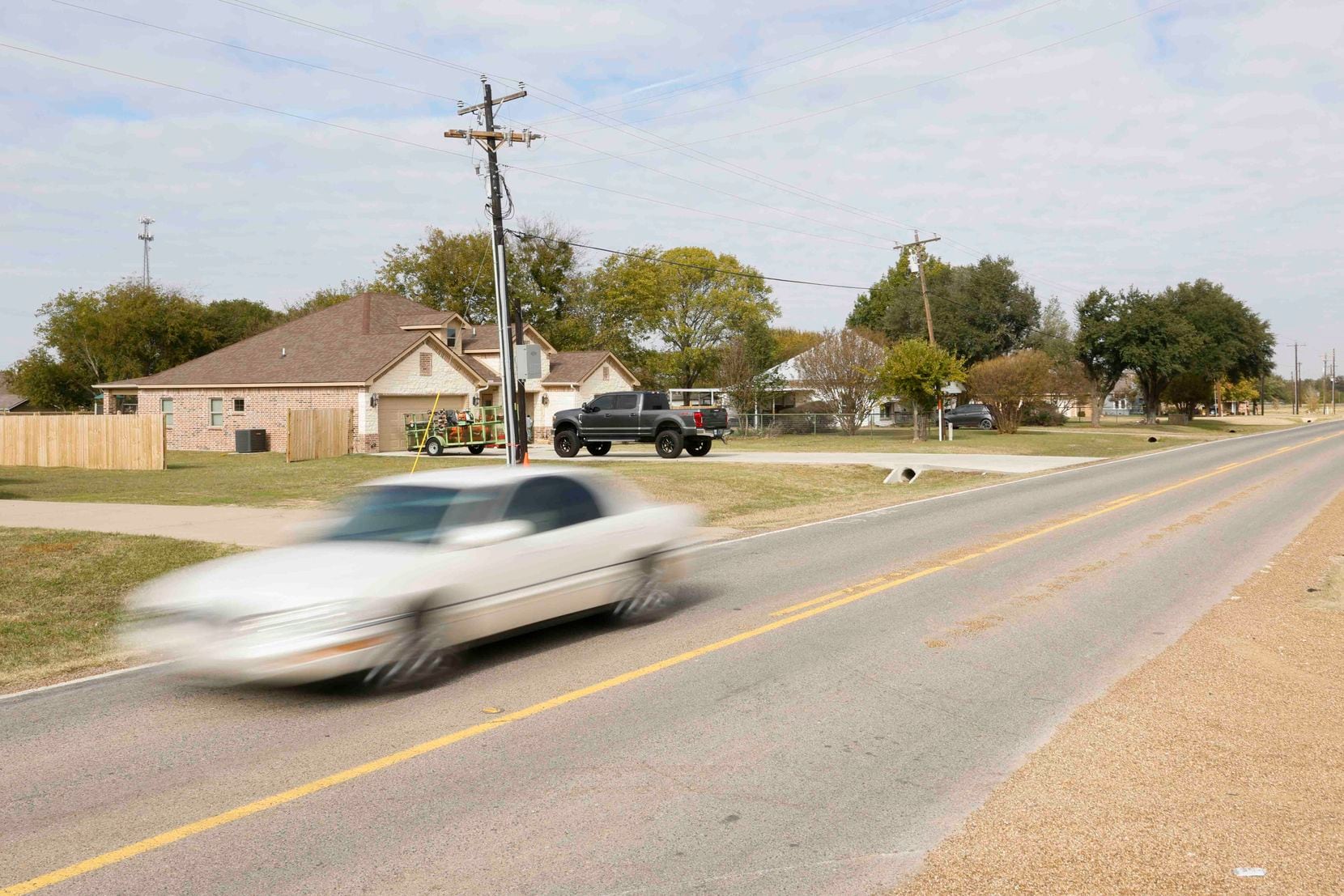Traffic passes by a housing development along FM 3080 in Mabank.