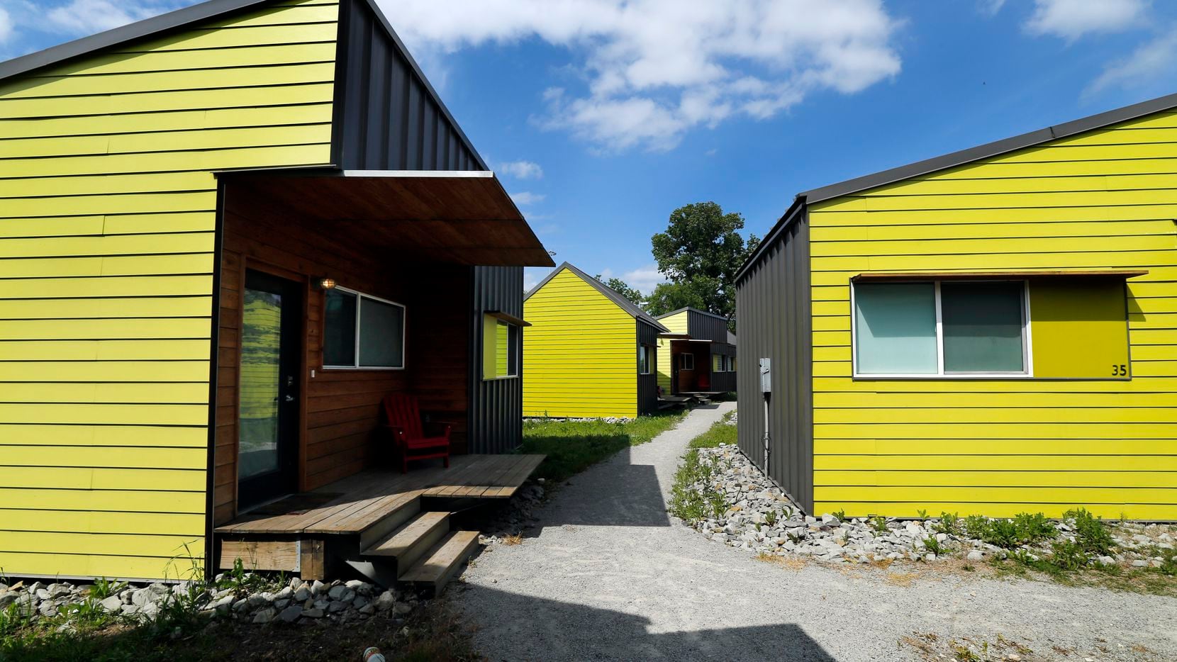 The Cottages at Hickory Crossing have brightly colored units with pathways between them. The units are designed by BC Workshop.
