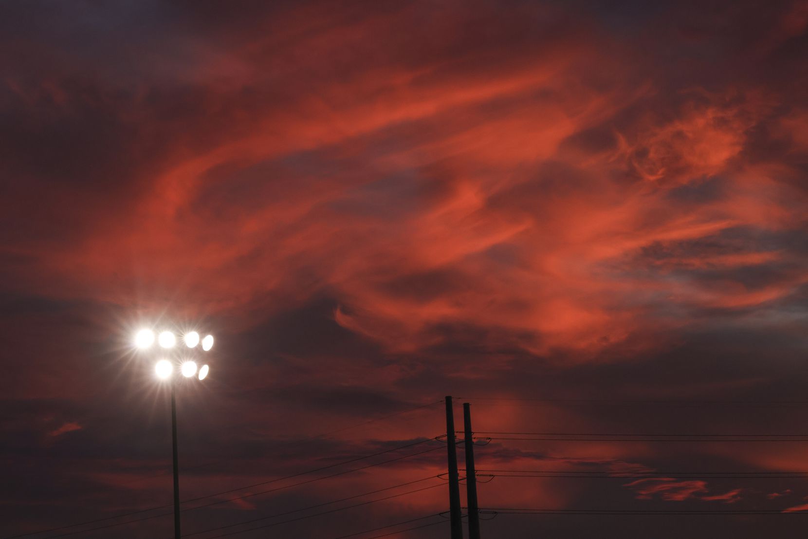 Clouds turn cotton candy colors after the sun sets during the football game between St....