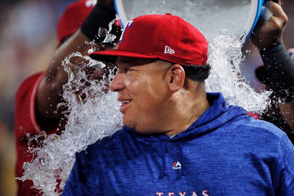 Texas Rangers starting pitcher Bartolo Colon is doused after his 246th career win, the most...