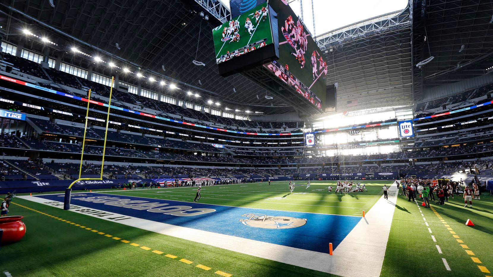The sun shines through the open end zone doors and roof as the Dallas Cowboys faced the Washington Football Team at AT&T Stadium in Arlington, Thursday, November 26, 2020.