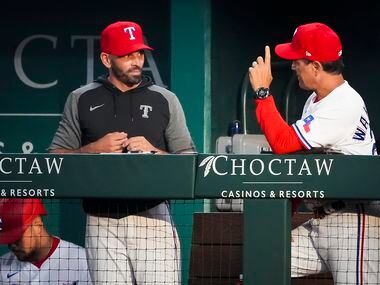 Texas Rangers manager Chris Woodward (left) talks with bench coach Don Wakamatsu in the...