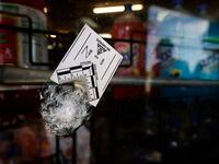 A bullet hole in the Discount Food Mart window is marked at South Westmoreland Road and...