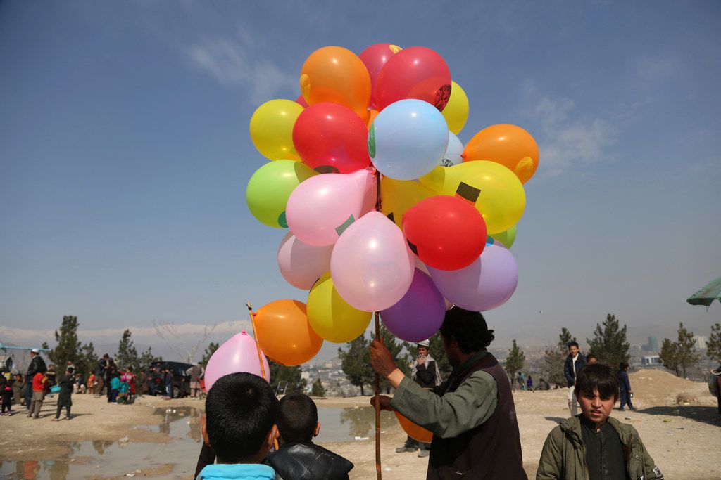An Afghan man sells balloons during celebrations for Nowruz, the Persian New Year, in Kabul, Wednesday, March 21, 2018. Nowruz is  celebrated on the first day of spring in countries including Afghanistan, Tajikistan, and Iran. (AP Photos/Rahmat Gul)