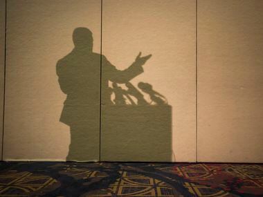 Richard Spencer casts a shadow on the wall as he addresses the media during a news...