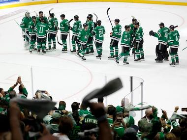 Dallas Stars players congratulate one another following a 4-2 win over the Calgary Flames in...