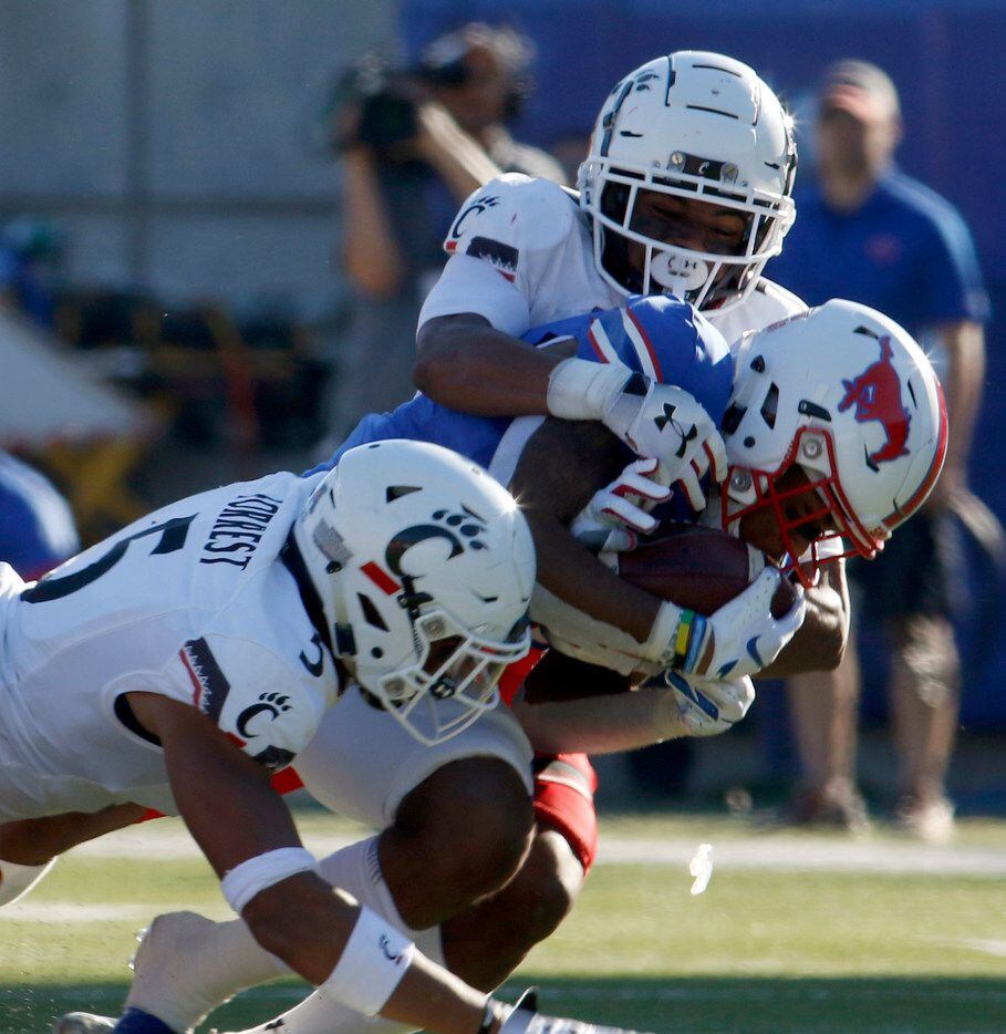 SMU receiver Reggie Roberson,Jr. secures the ball as he pulls in a 42-yard reception while...