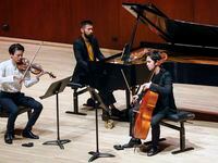 Violinist Stefan Jackiw (left), pianist Conrad Tao (center) and cellist Jay Campbell perform...
