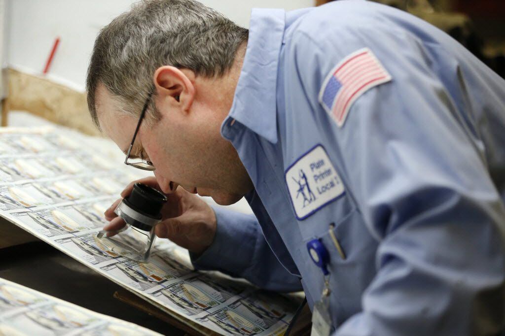 Bill Herr inspects a page of $100 notes at the Bureau of Engraving and Printing in Fort...