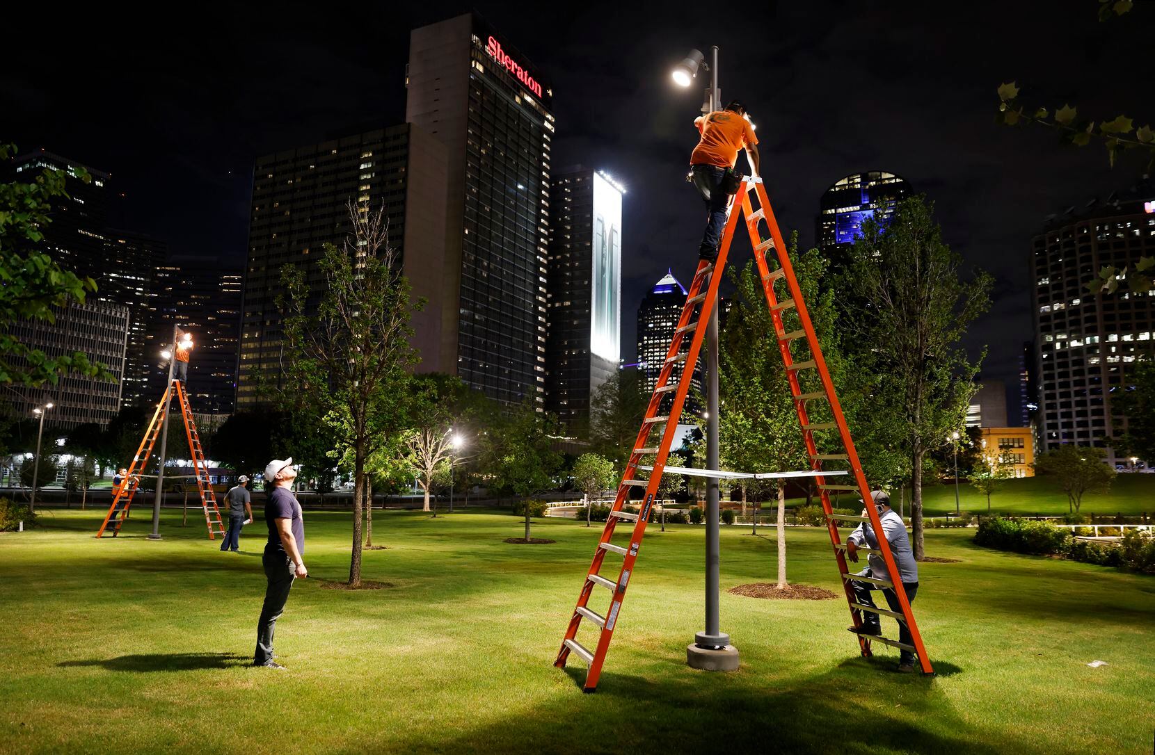 A crew led by Ross Murphy of Oldner Lighting (left) adjust spot lights to illuminate the...
