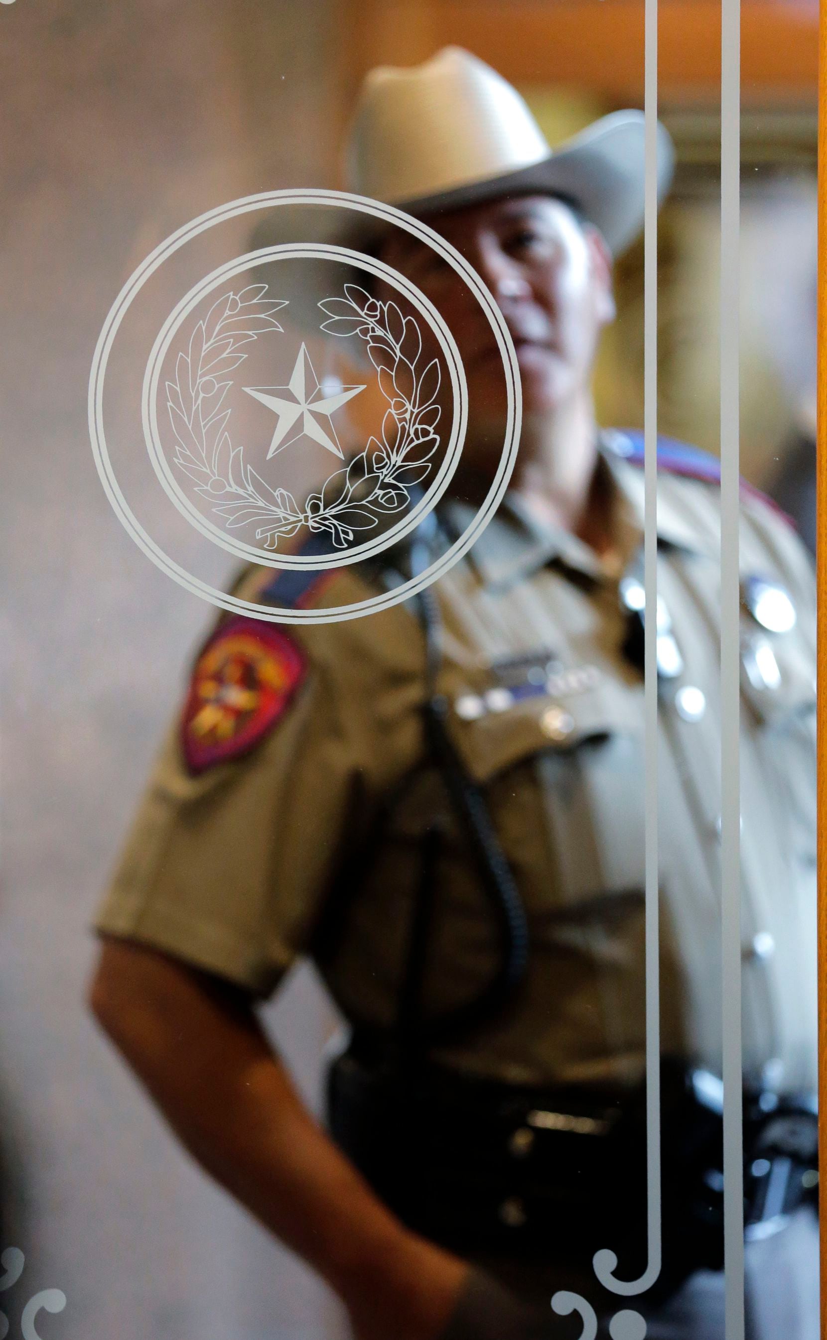 A Texas state trooper stands outside of a hearing where lawmakers discuss whether to...
