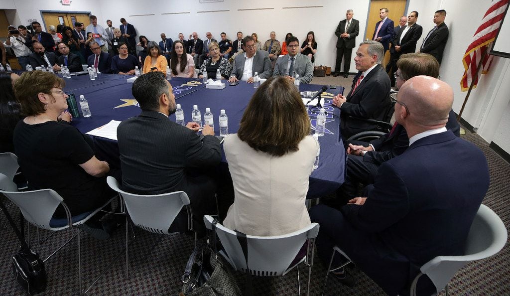 Texas Gov. Greg Abbott (right) speaks with families of victims and survivors of the Aug. 3 shooting at Walmart in El Paso on, Thursday, Aug. 29, 2019. About 30 representatives from law enforcement and non governmental agencies were part of a  roundtable discussion of public safety. 