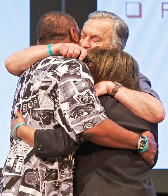 
Harville Hendrix (center) hugged Marvin and Terri Wyche after leading them through a...
