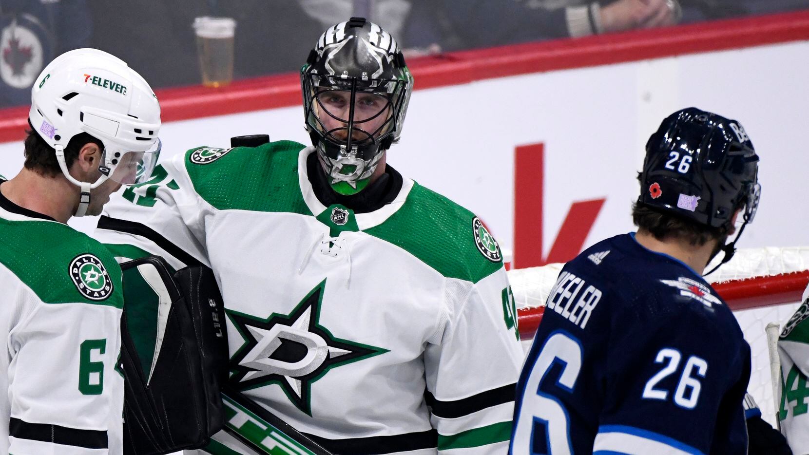 Dallas Stars goaltender Scott Wedgewood (53) has the puck resting on his shoulder after...