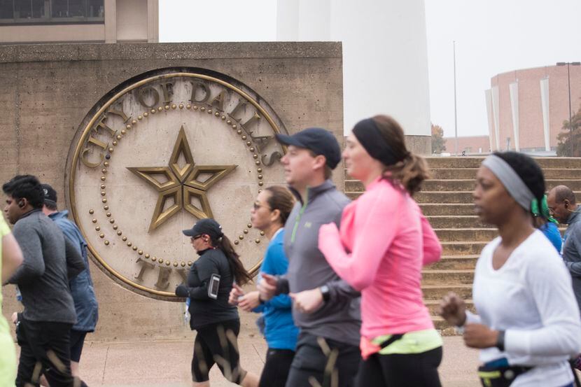 Runners begin the BMW Dallas Marathon and half marathon.