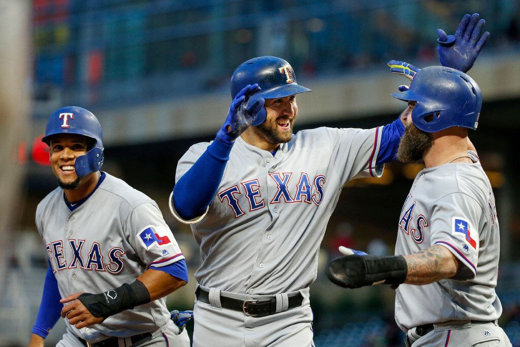 Texas Rangers third baseman Joey Gallo celebrates his three-run homer with Mike Napoli,...