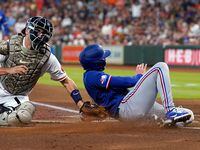 Texas Rangers' Brad Miller, right, is tagged out by Houston Astros catcher Jason Castro...
