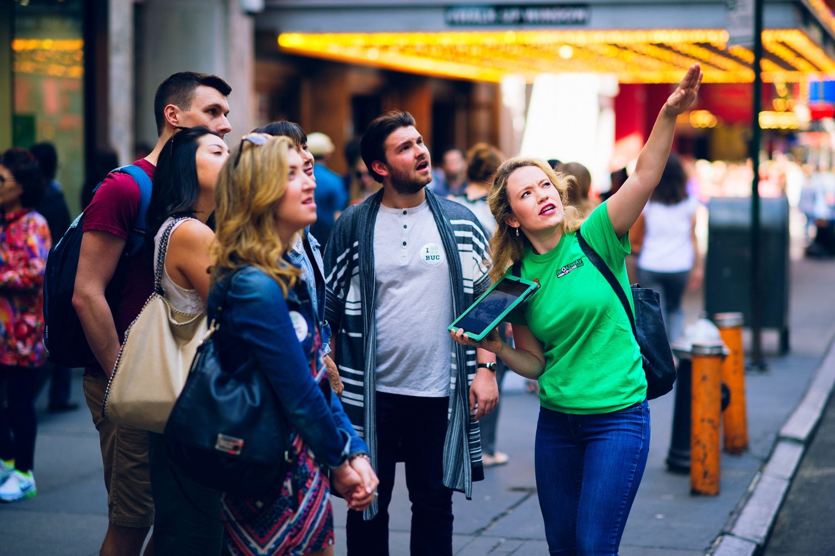 The green-clad guides for the Broadway Up Close tour company carry an iPad filled with...