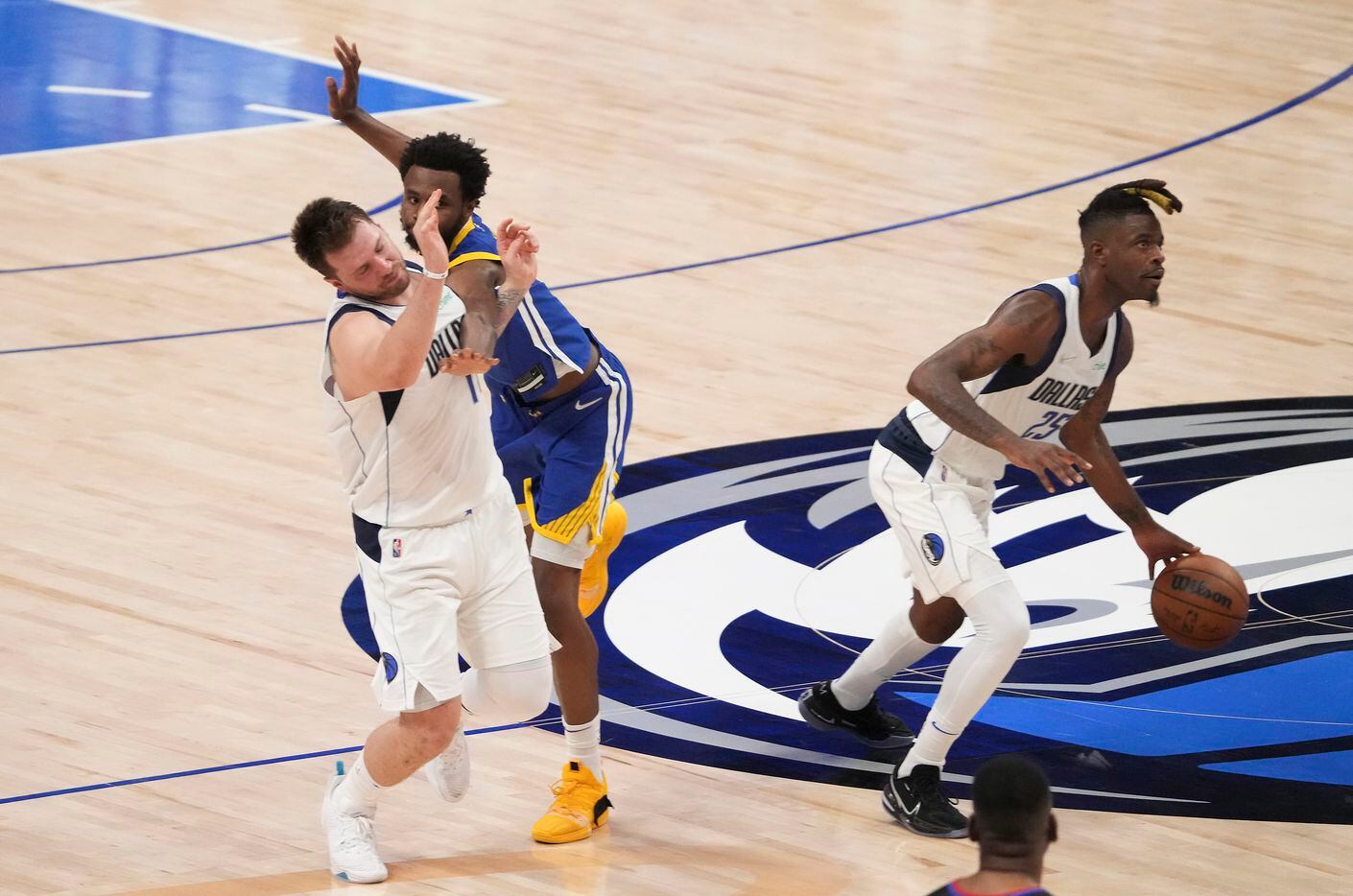 Dallas Mavericks guard Luka Doncic (77) is fouled by Golden State Warriors forward Andrew...