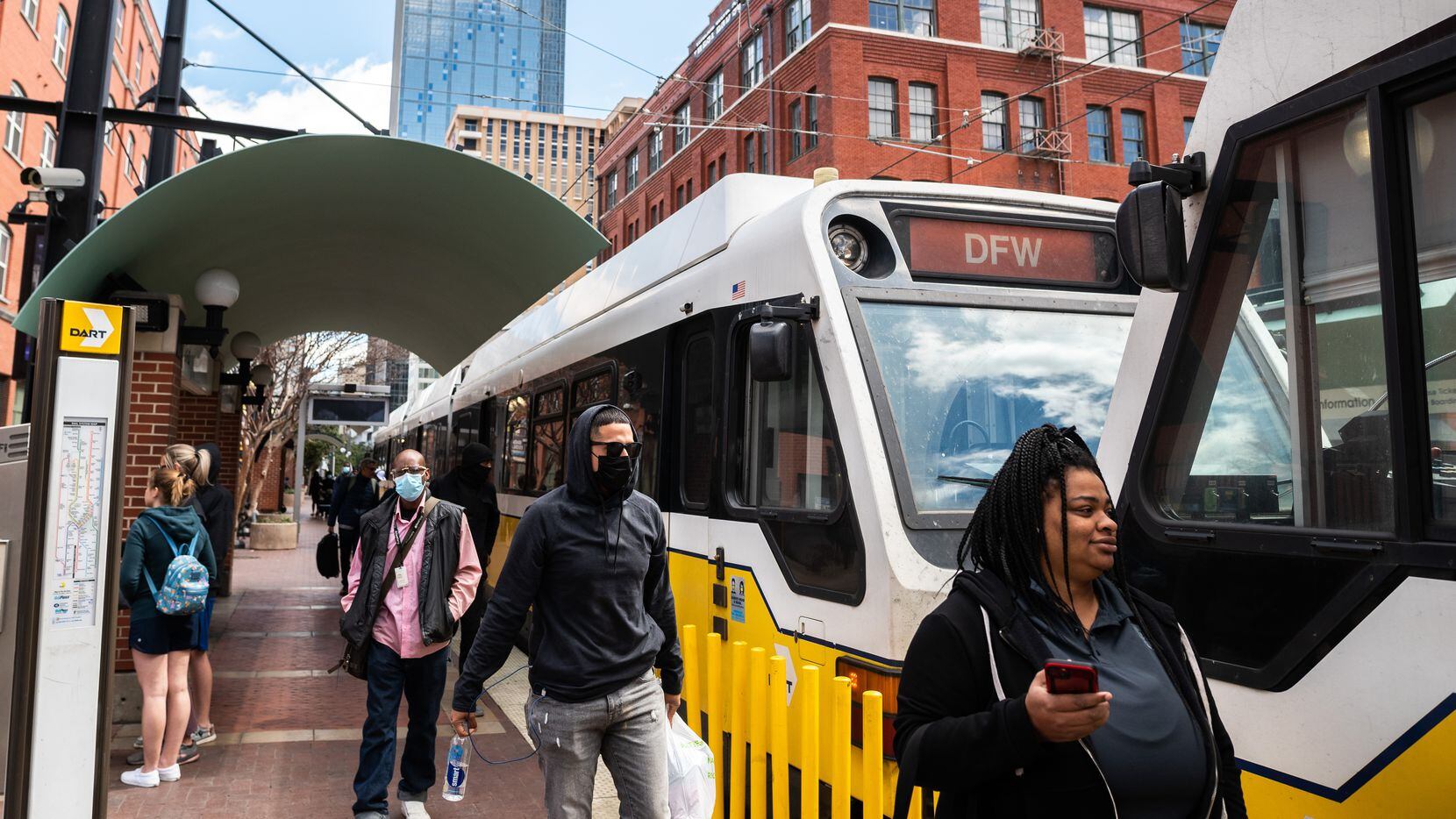 Riders enter and exit a DART train at the West End Station in downtown Dallas, in March 2022.