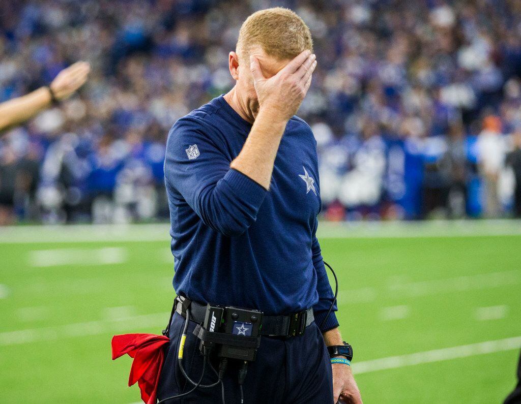 Dallas Cowboys head coach Jason Garrett puts his hand on his forehead after officials called...