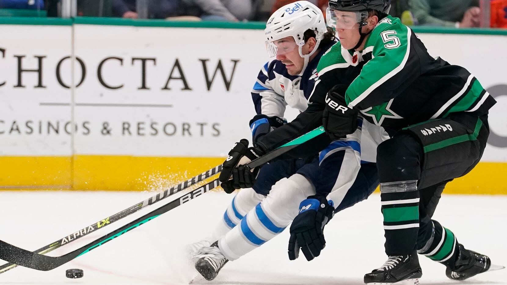 Winnipeg Jets center Michael Eyssimont (23) skates with the puck against Dallas Stars...