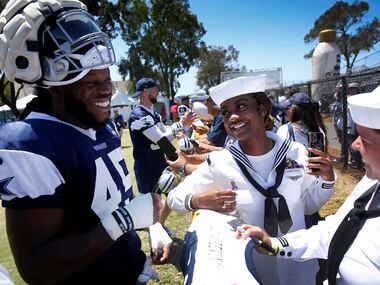Navy logistics specialists Janisha Stout (center) laughs with Dallas Cowboys rookie...
