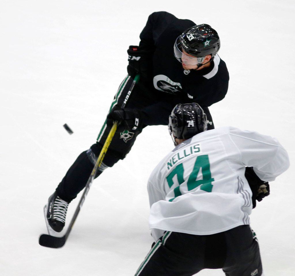 Dallas Stars Emil Djuse (33) and Dallas Stars Anthony Nellis (74) go after the puck during...