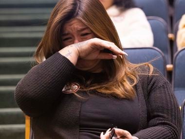 Lee Molina wipes tears away after providing public comment against the proposed sexually...