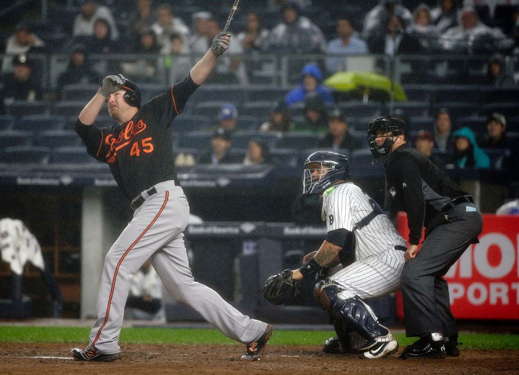 Baltimore Orioles' Mark Trumbo (45) follows through on a two-run home run against the New...